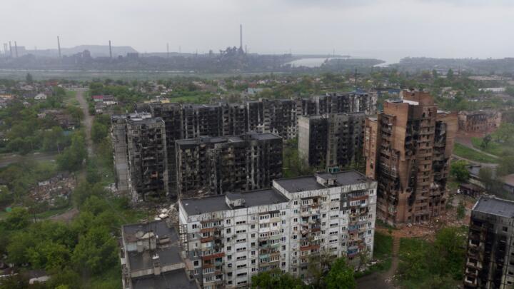 An aerial view of damaged residential buildings and the Azovstal steel plant in the background in the port city of Mariupol on May 18, 2022.