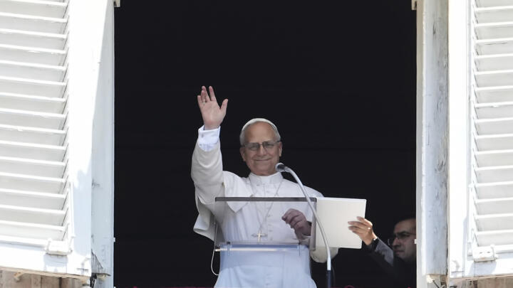 Pope Leo XIV appears at his studio's window to bless the faithful gathered in St. Peter's Square at the Vatican for the Angelus prayer, Sunday, July 6, 2025.