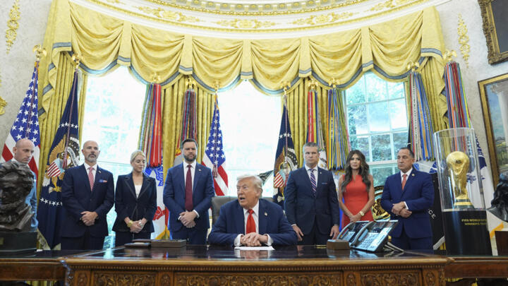 President Donald Trump speaks in the Oval Office of the White House surrounded by US officials on August 25, 2025.