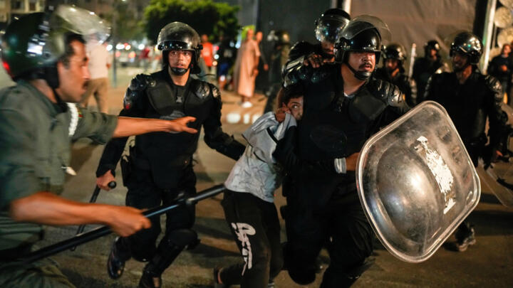A boy is detained as youth led protests calling for healthcare and education reforms turned violent, in Sale, Morocco, Wednesday, Oct. 1, 2025.
