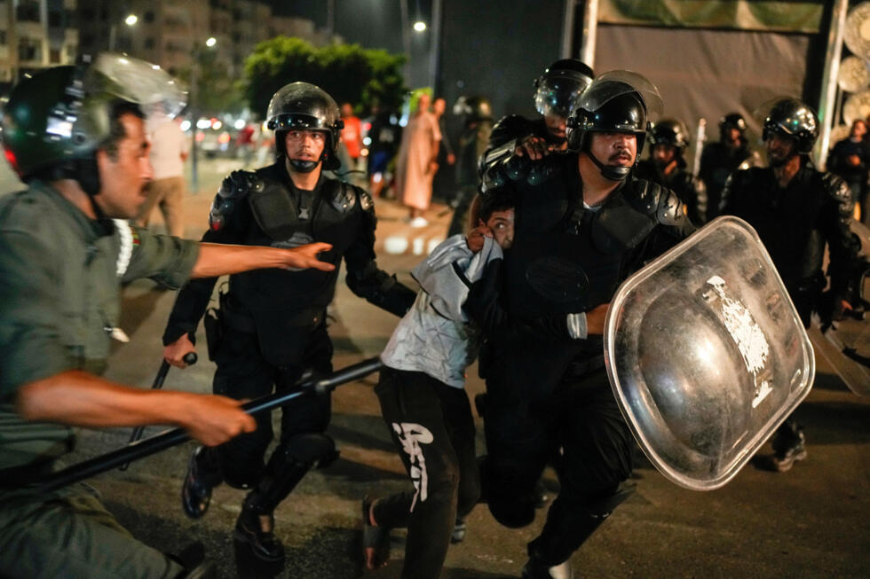 A boy is detained as youth led protests calling for healthcare and education reforms turned violent, in Sale, Morocco on October 1, 2025.