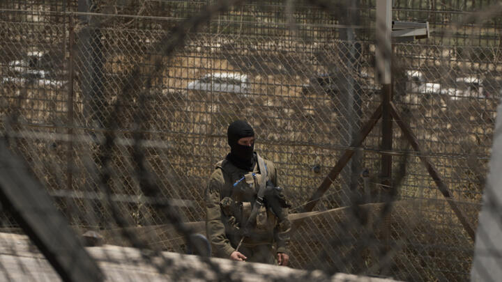 An Israeli soldier standing guard at the Israeli-controlled Golan Heights town of Majdal Shams, on July 17, 2025.