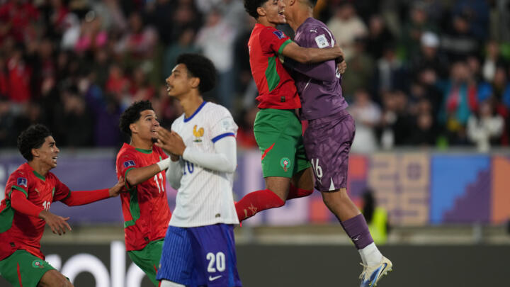 Teammates celebrate with Morocco's goalkeeper Abdelhakim Mesbahi after defeating France in Valparaiso, Chile, on October 15, 2025.