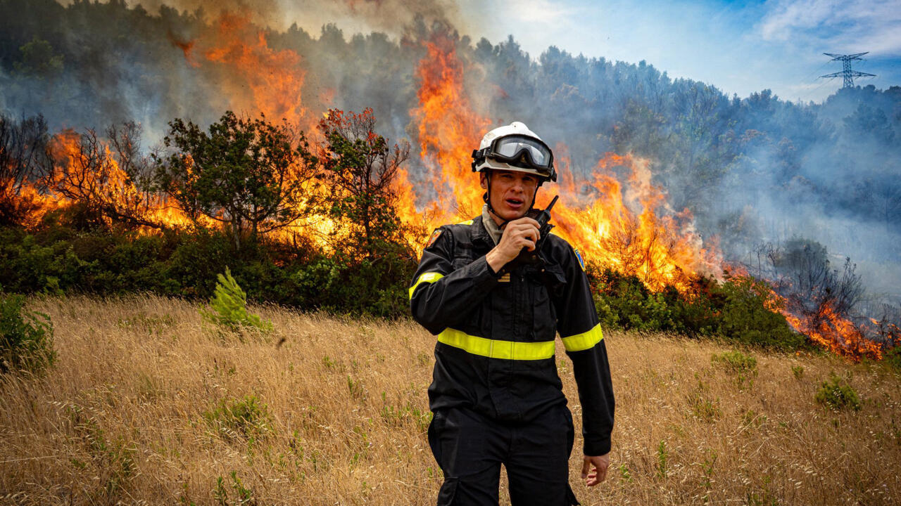 This photograph taken on August 6, 2025 shows a firefighter at work to extinguish a wildfire raging in the department of Aude, near Ribaute and Saint-Laurent-de-la-Cabrerisse, in the south of France.