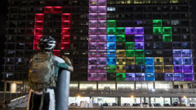 A file photo showing a child participating in a giant Tetris tournament projected on the façade of a building in Tel Aviv on August 30, 2016.