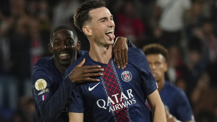 PSG's Fabian Ruiz, reacts after scoring his side opening goal with PSG's Ousmane Dembele, left, during the League One soccer match Paris Saint-Germain against Angers.