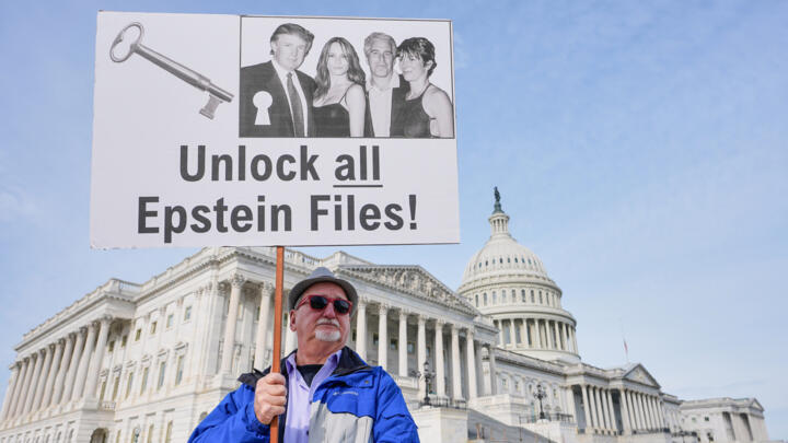 A protesters holds a sign calling for the release of all Epstein files at the Capitol in Washington, on December 18, 2025.