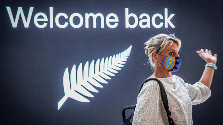 A passenger reacts upon arrival from New Zealand at Sydney International Airport on October 16, 2020.