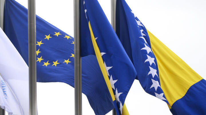 European Union flag flutters next to the flag of Bosnia and Herzegovina in front of the Council of Ministers building in Sarajevo, Bosnia-Herzegovina, March 12, 2024. 