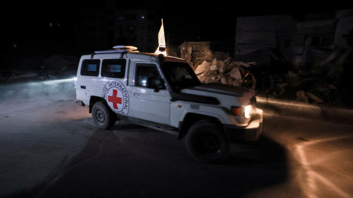 A Red Cross vehicle transports the bodies of hostages after their handover by Hamas in Gaza on October 15, 2025.