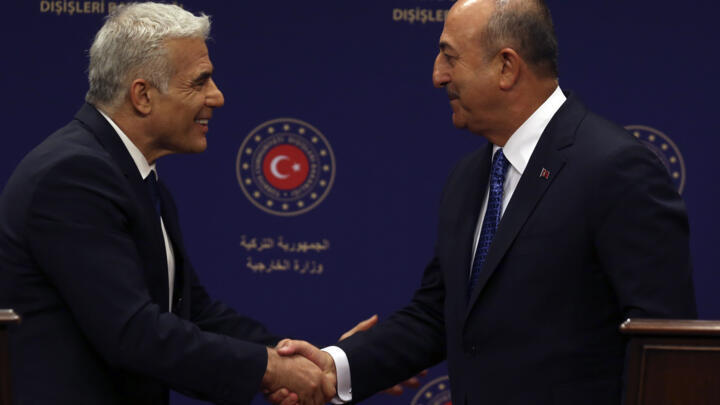 File photo of Israel's Yair Lapid and Turkish Foreign Minister Mevlut Cavusoglu taken on June 23, 2022 in Ankara, Turkey.
