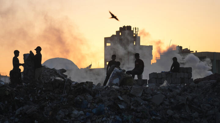 Palestinians search for firewood and plastic at a landfill in Gaza City on Saturday, October 25, 2025.
