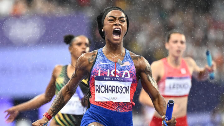 US sprinter Sha'Carri Richardson celebrates her team's come-from-behind 4x100m relay gold medal.