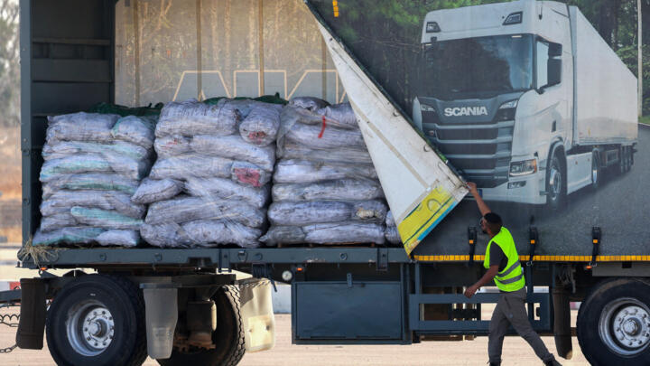 A truck carrying humanitarian aid drives through the Kerem Shalom crossing between southern Israel and the Gaza Strip, on May 22, 2025.