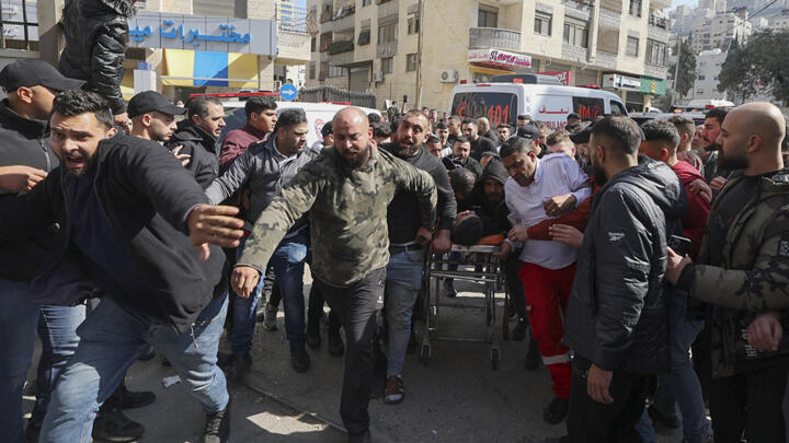 A wounded Palestinian is rushed to hospital following an Israeli raid in the occupied West Bank city of Nablus on February 22, 2023.