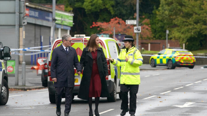 Britain's Prime Minister Keir Starmer and his wife Victoria arrive to meet emergency workers near Heaton Park Hebrew Congregation synagogue in Manchester on October 3, 2025.