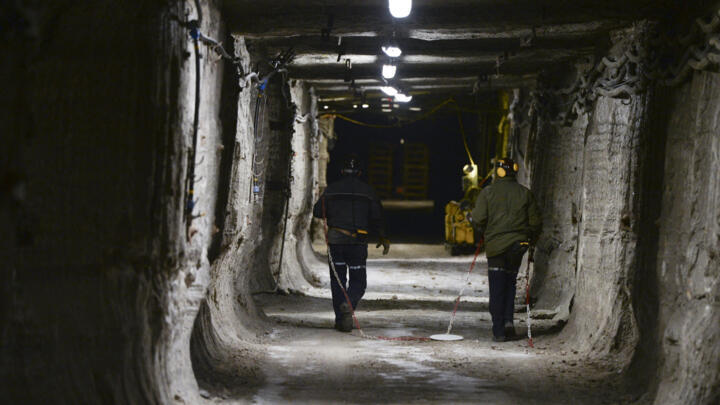 Employees walk in a mining gallery in the StocaMine hazardous waste storage centre in Wittelsheim, eastern France, on January 24, 2019.