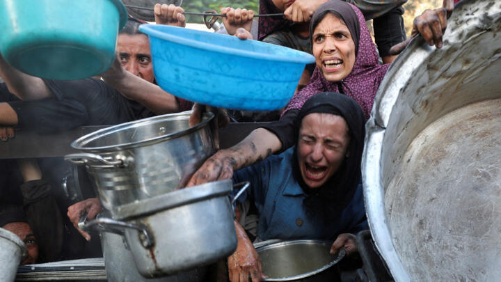 File photo: Palestinians react as they ask for food from a charity kitchen, amid a hunger crisis, in Gaza City, July 14, 2025. 