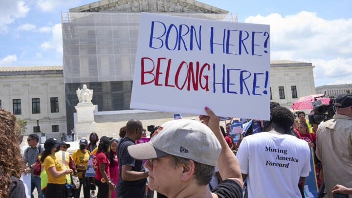 Jenny Harris, of Baltimore, protests in support of birthright citizenship and the immigrant community on May 15, 2025, outside of the Supreme Court in Washington DC.