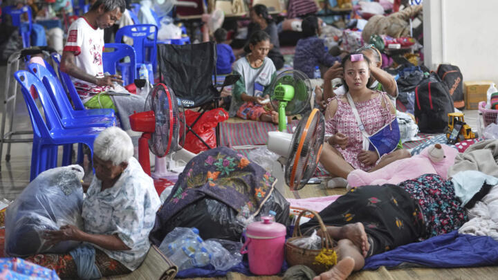 Thai residents who fled homes following clashes between Thai and Cambodian soldiers rest at an evacuation center in Surin province, Thailand, Sunday, July 27, 2025.