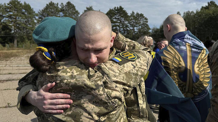 Ukrainians are greeted after being released in a prisoner exchange at an undisclosed location in Ukraine, September 13, 2024.