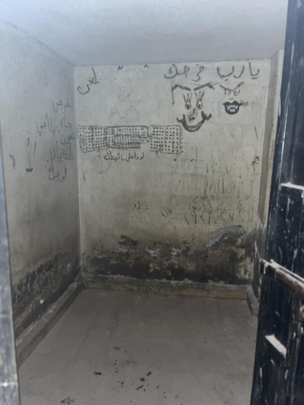 Drawings, dates and cries for help line the walls of the solitary confinement cells of the Palestine Branch, Damascus, May