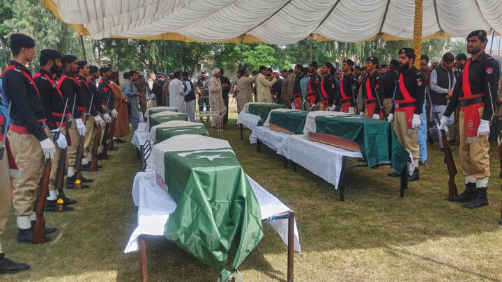 Officials and others attend funeral prayers for officers killed in an attack on a police training centre in northwestern Pakistan, on October 11, 2025.