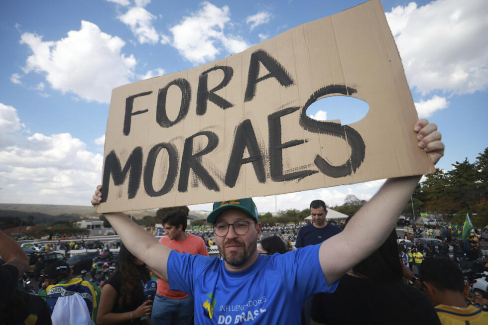 Un partidario del expresidente de Brasil Jair Bolsonaro sostiene un cartel en portugués que dice "Moraes, vete", en referencia al juez del Tribunal Supremo Alexandre de Moraes, durante una caravana de motocicletas que protesta contra un juicio del Tribunal Supremo en el que Bolsonaro se enfrenta a cargos por su presunta participación en un intento de golpe de Estado en 2022, en Brasilia, Brasil, el martes 29 de julio de 2025.