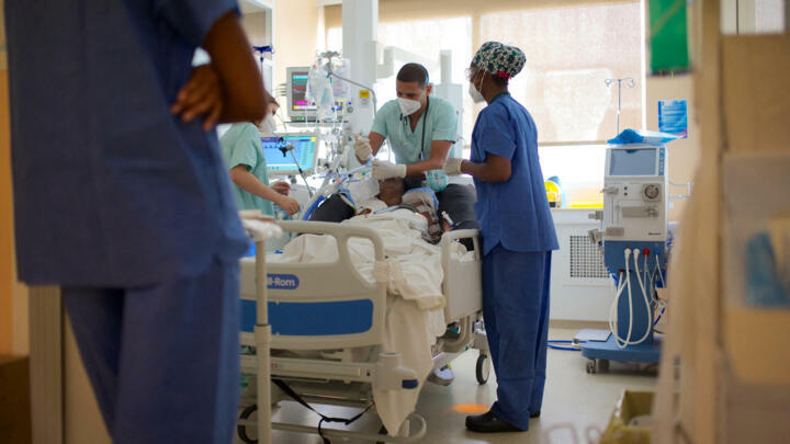 A medical staff member intubates a Covid-19 patient at the intensive care unit of the hospital Les Abymes (Centre hospitalier universitaire) in Pointe-a-Pitre, on the French Caribbean archipelago of Guadeloupe, on August 6, 2021.