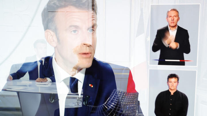 France's President Emmanuel Macron is seen on a television screen in Paris during a live interview broadcasted on the French TV channel TF1's evening news and French public television news channel France 2 on September 24, 2023.