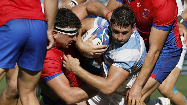 Argentina's Juan Martin Gonzalez, right, carries the ball as Chile's Raimundo Martinez attempts a tackle during the Rugby World Cup Pool D match between Argentina and Chile at the Stade de la Beaujoire, Nantes, France, Saturday, Sept. 30, 2023.