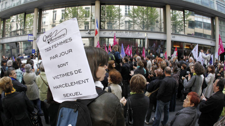 A woman holds a placard reading "722 women each day are victims of sexual harassment " as she takes part in a demonstration on May 5, 2012, in Paris, to protest against the Constitutional Council's decision to immediately repeal the current French sexual harassment law. 