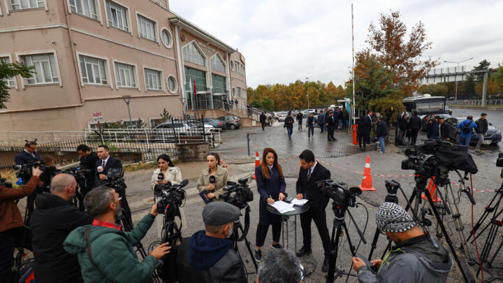 Reporters wait outside the courthouse ahead of the verdict, in Ankara, Turkey, on October 24, 2025.
