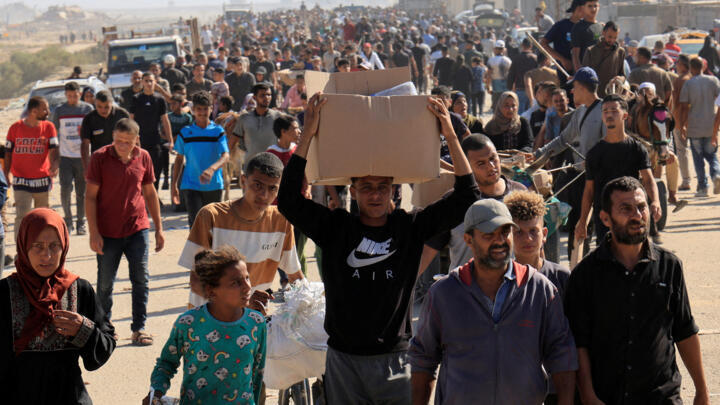 Palestinians gather near an aid distribution site run by the US-backed Gaza Humanitarian Foundation, in Rafah, in the southern Gaza Strip, May 27, 2025.