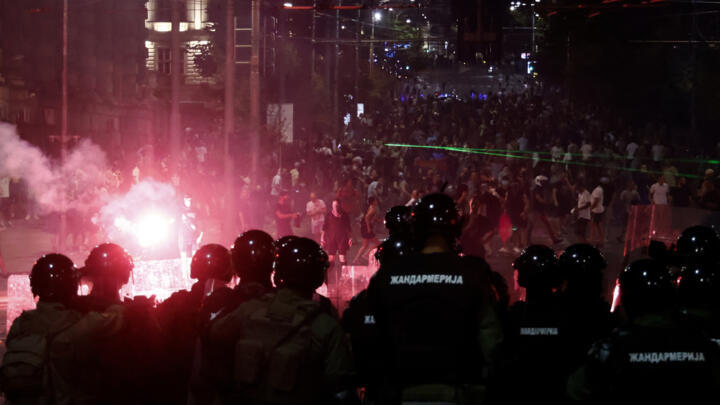 Riot police confront anti-government protesters in Belgrade on August 15, 2025.