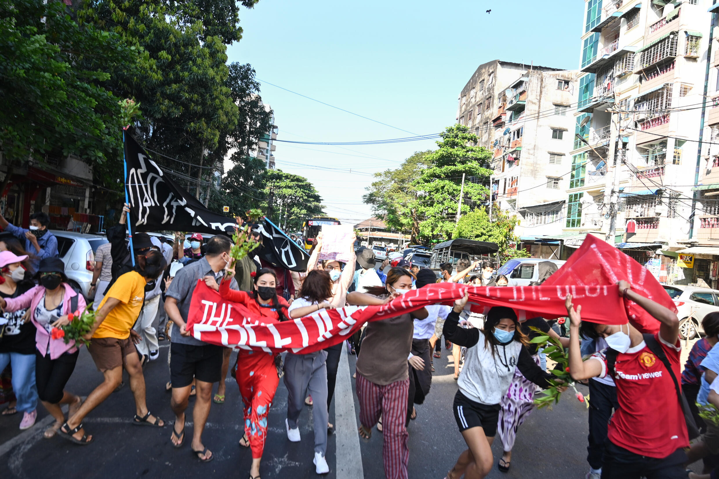 Anti-military protesters ran from security forces in Yangon