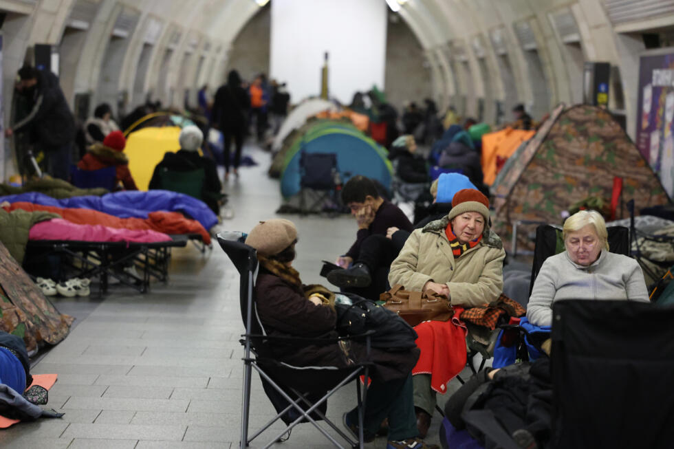 People take shelter at a metro station during Russian air attacks in Kyiv.