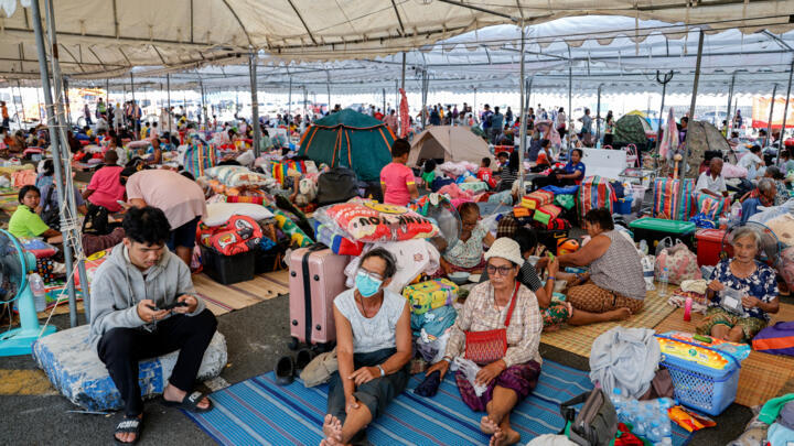 Evacuated Thai residents gather at a temporary shelter following clashes along the Thailand-Cambodia border in Buriram province on December 8, 2025