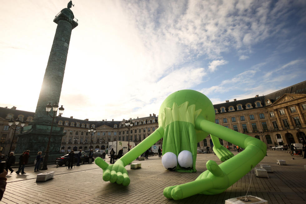 An inflatable art piece called "Kermit the Frog, Even" by American artist Alex Da Corte is displayed on the Place Vendôme in Paris as part of the Art Basel art fair on October 24, 2025.