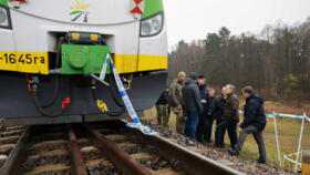 Koleje Mazowieckie train sits on the track with police tape as Polish Prime Minister Donald Tusk visits the site of a blast on railway of the Warsaw-Lublin line in Mika, Poland, November 17, 2025.