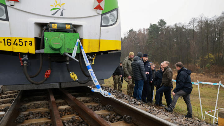 Koleje Mazowieckie train sits on the track with police tape as Polish Prime Minister Donald Tusk visits the site of a blast on railway of the Warsaw-Lublin line in Mika, Poland, November 17, 2025.