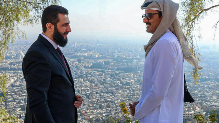 Syria's interim president Ahmed al-Sharaa (L) showing Qatar's Emir Sheikh Tamim bin Hamad Al-Thani a view of Damascus from Qasyoun mountain, on January 30, 2025.
