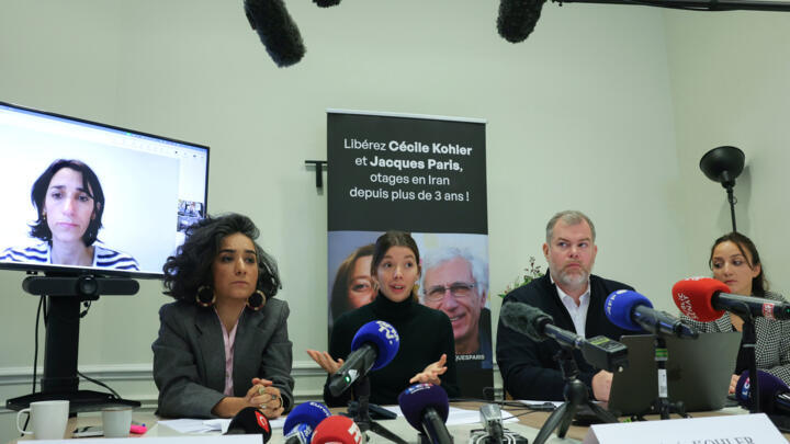 Anne-Laure Paris appears on a screen as French lawyer Chirinne Ardakani, Noémie Kohler, French lawyers Martin Pradel and Emma Villard hold a press conference in Paris on October 16, 2025.