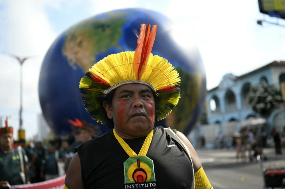 Under a baking sun, Indigenous people mixed with activists demonstrated in a festive atmosphere in Belem, Brazil.