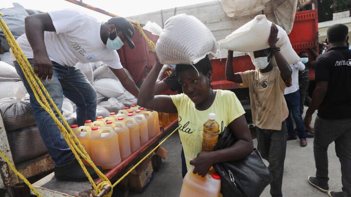 Residents of the rural town of Camp-Perrin receive food from the World Food Programme (WFP) near Les Cayes, Haiti on August 19, 2021.