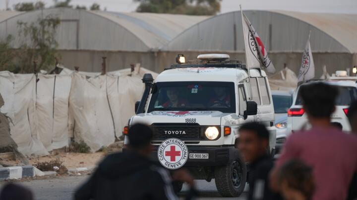 Red Cross vehicles carry two bodies believed to be deceased hostages toward the Kissufim border crossing to be transferred to Israeli authorities on October 30, 2025.
