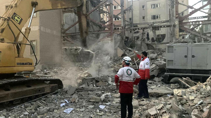 A photo provided by the Iranian Red Crescent on June 19, 2025, shows rescue workers and debris from a building destroyed during an Israeli attack in Tehran.