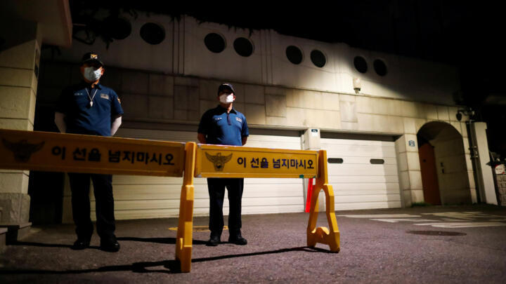 Police officers stand guard in front of the residence of Seoul Mayor Park Won-soon as rescue workers conduct a search operation in Seoul, South Korea, July 10, 2020.