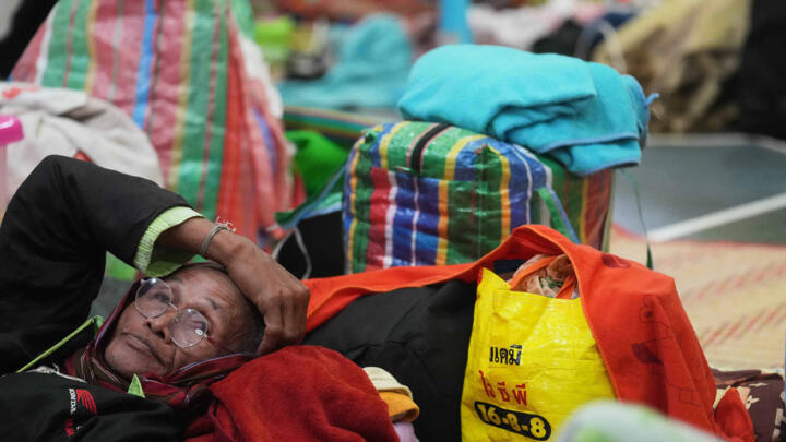A Thai resident who fled home following the clashes between Thai and Cambodian soldiers, rests at an evacuation center in Surin province, Thailand on December 10, 2025.