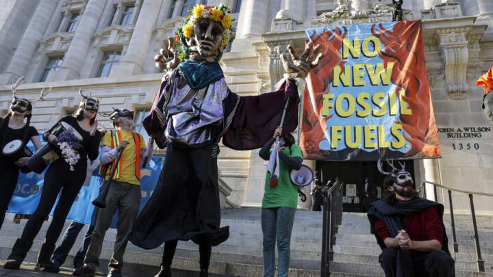 Environmental activists with the group Extinction Rebellion DC participate in an Earth Day rally against fossil fuels at the Wilson Building on April 22, 2022 in Washington, DC.